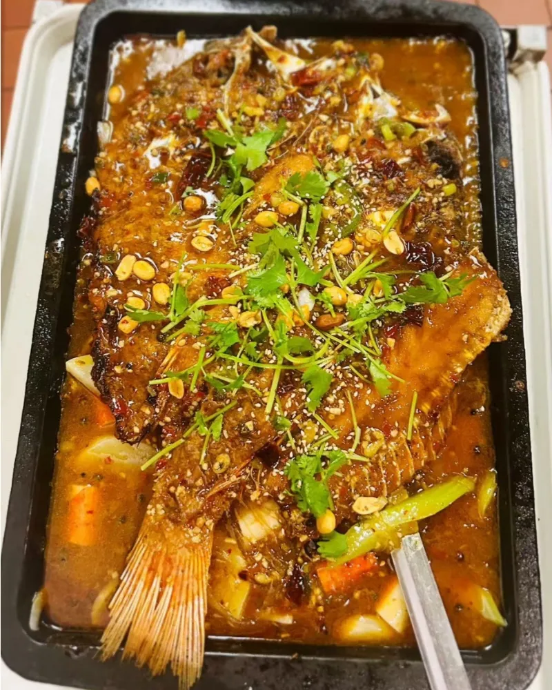 Spicy grilled fish with cilantro, peanuts and dried chilies at Liu Roast Fish, an Chinese Restaurant in City of Industry